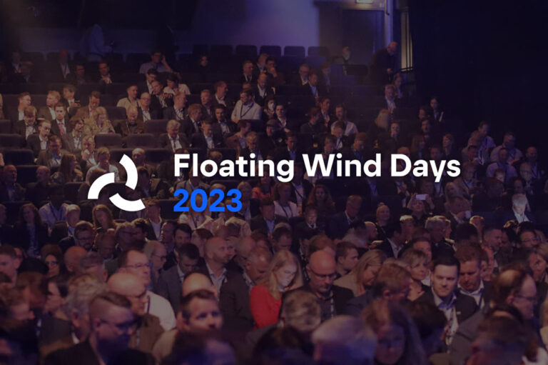 The logo of Floating Wind Days 2023, overlayed on a picture of an audience in a large room.