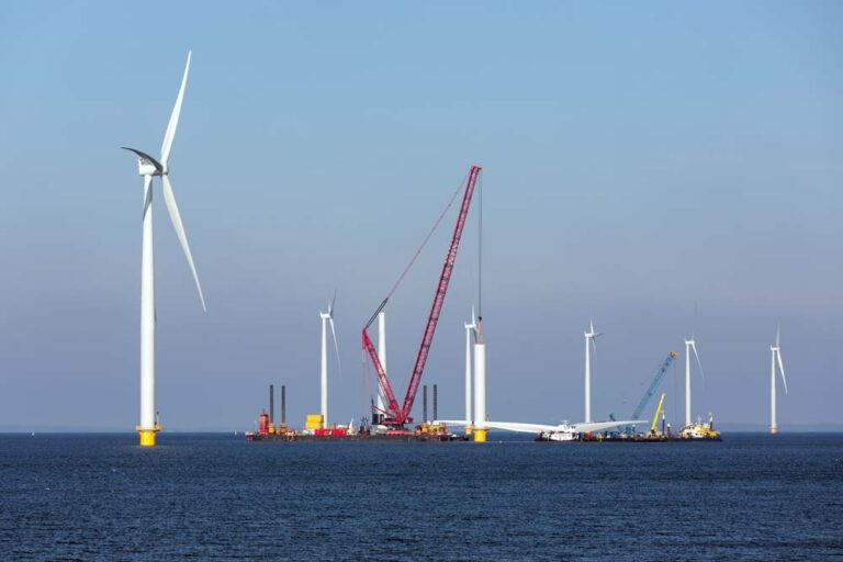 Wind turbines being built at sea.